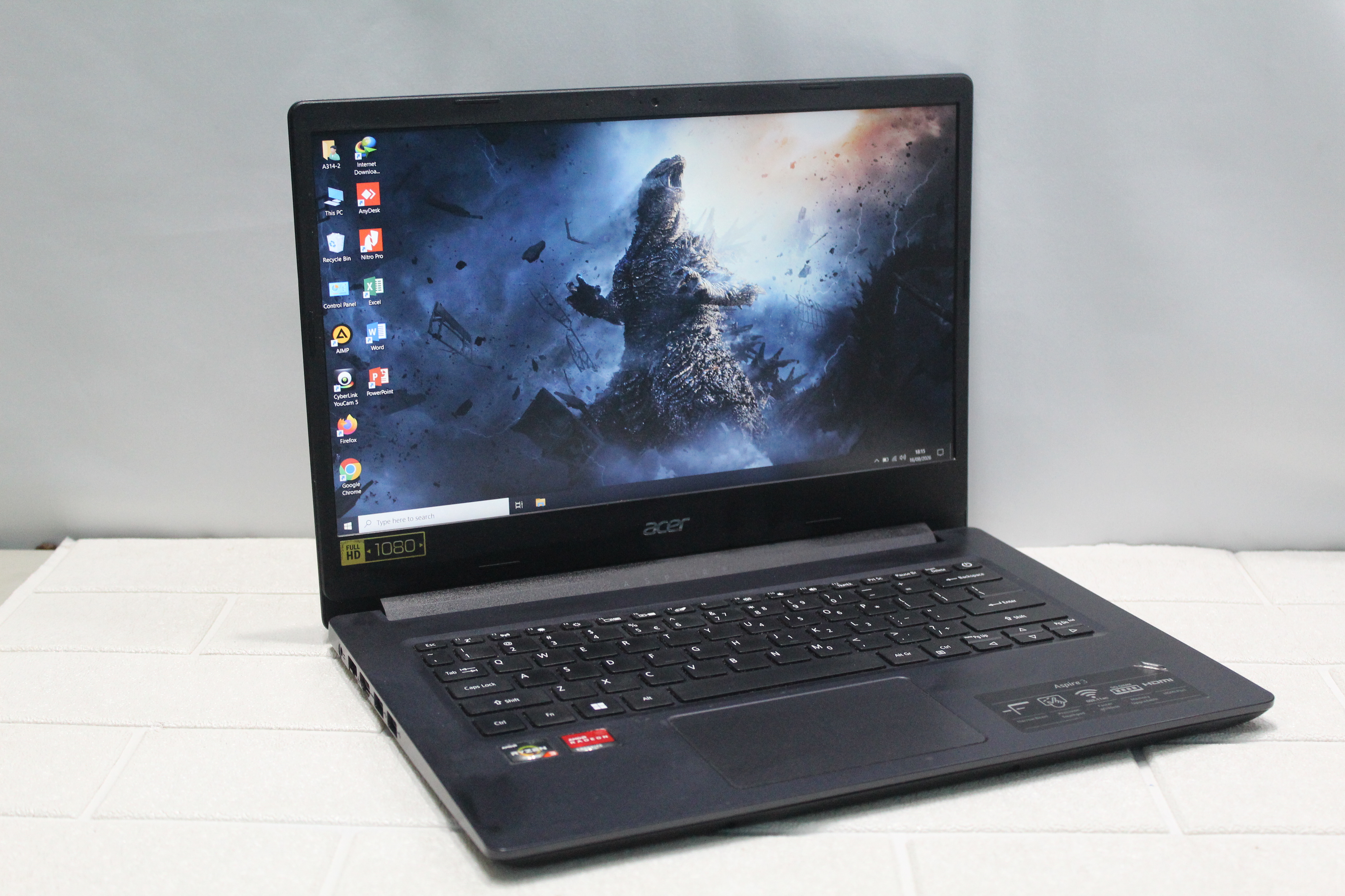 A sleek laptop and smartphone placed on wooden flooring, showcasing contemporary technology.