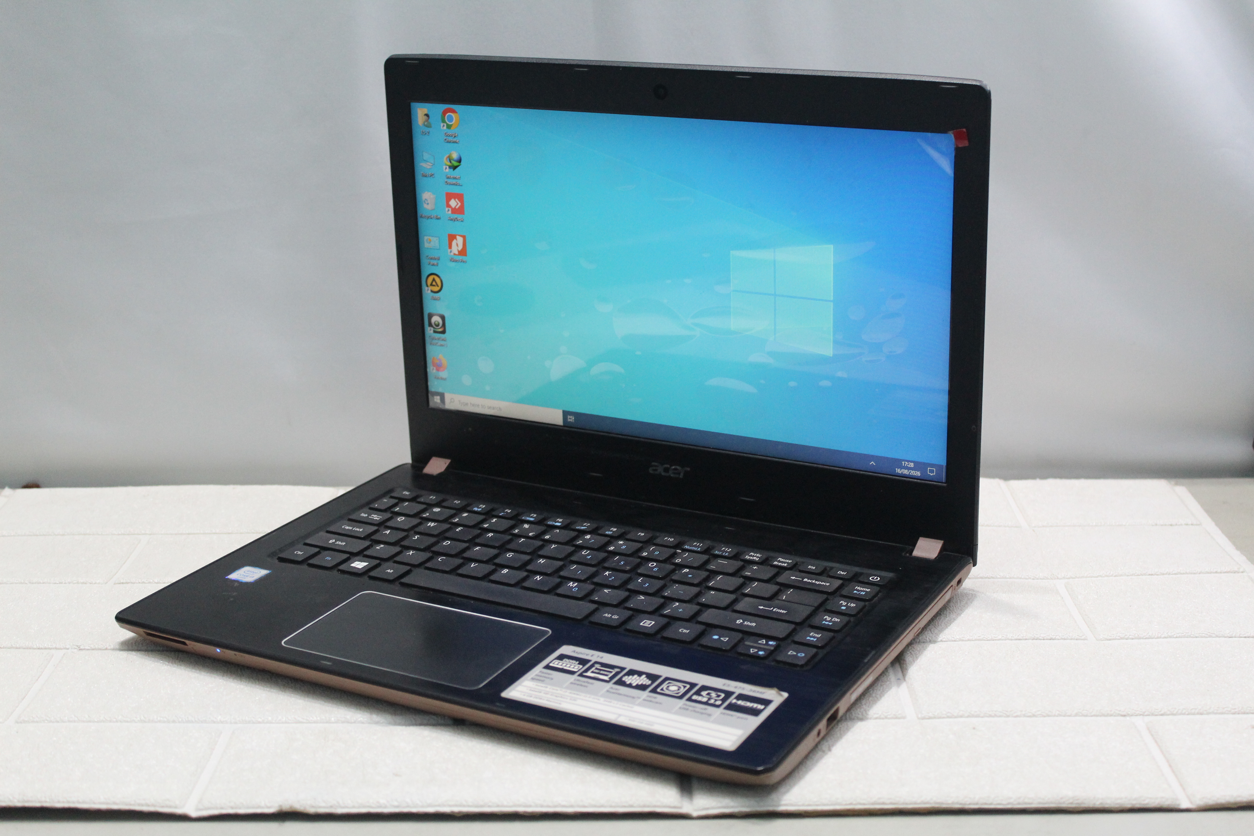 A sleek laptop and smartphone placed on wooden flooring, showcasing contemporary technology.